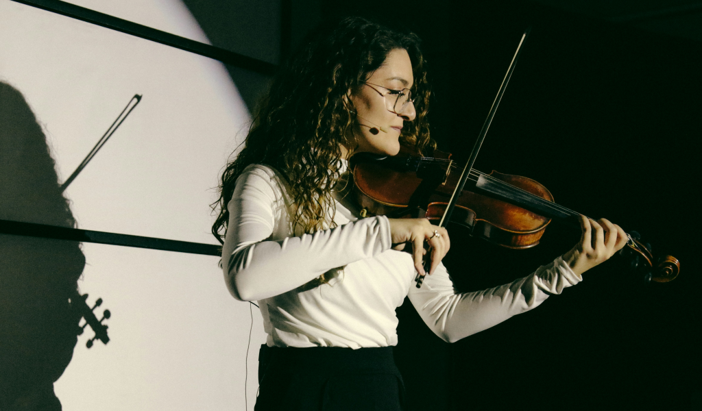 violin teacher on stage playing violin