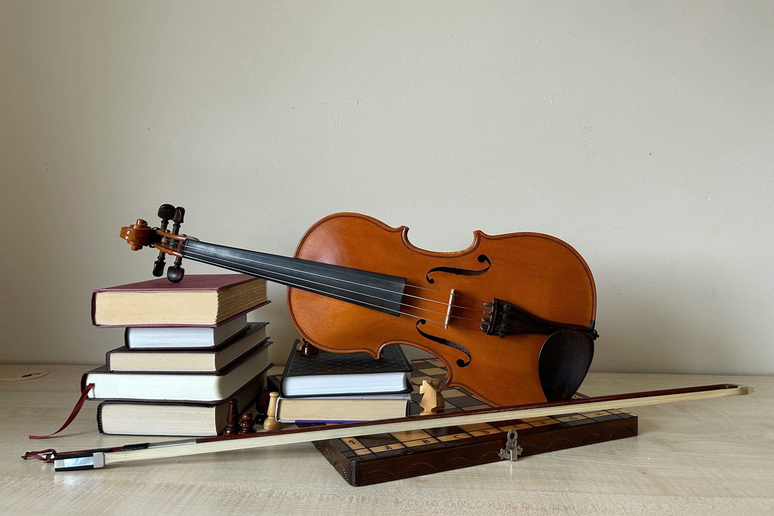 violin balanced on books