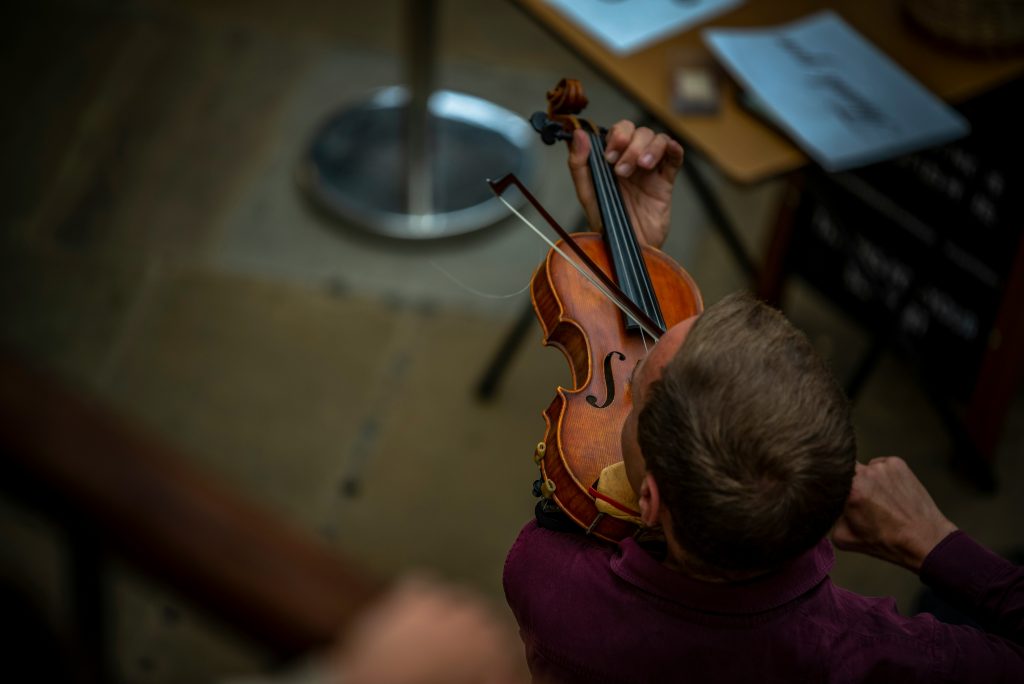 man playing violin seen from above